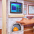 Interactive wooden dollhouse fireplace with light-up flames and touchscreen TV panel with sound effects