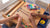 Children make colorful bracelets at a KidKraft activity table with built-in storage and craft supplies.