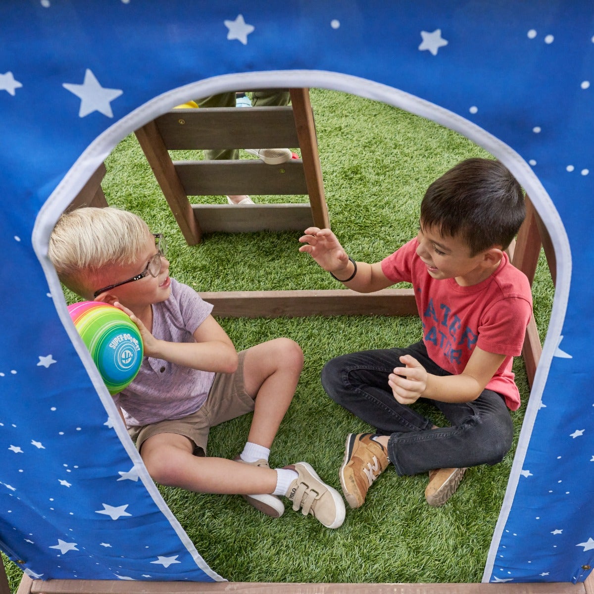 Secret Hideout: Enter the cutout door in the canvas underneath the deck and discover a cozy area for a clubhouse, ball pit, sandbox or more.